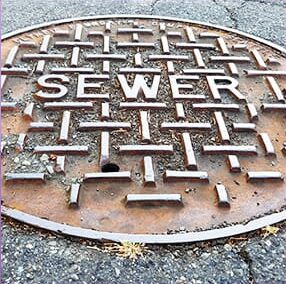 Image of a sewer in the road.