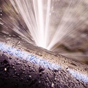 Image of a water pipe bursting.